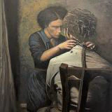 This painting depicts a solemn and intimate moment between two individuals, where a woman is carefully cutting the hair of a man sitting with his back to the viewer, set against a dark, textured background that enhances the emotional depth of the scene.