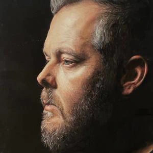 A contemplative side-profile portrait rendered in richly detailed watercolor, capturing quiet strength through dramatic light, shadow, and lifelike realism.