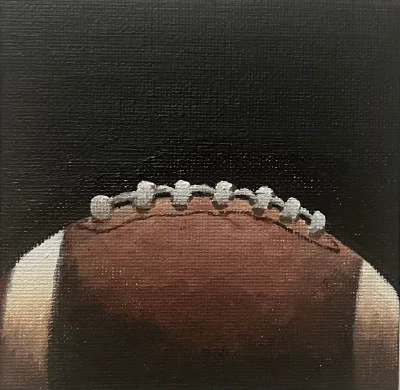 Tiny Football (2024) by Ben Young This painting by Ben Young is a close up oil painting of an american football ball.