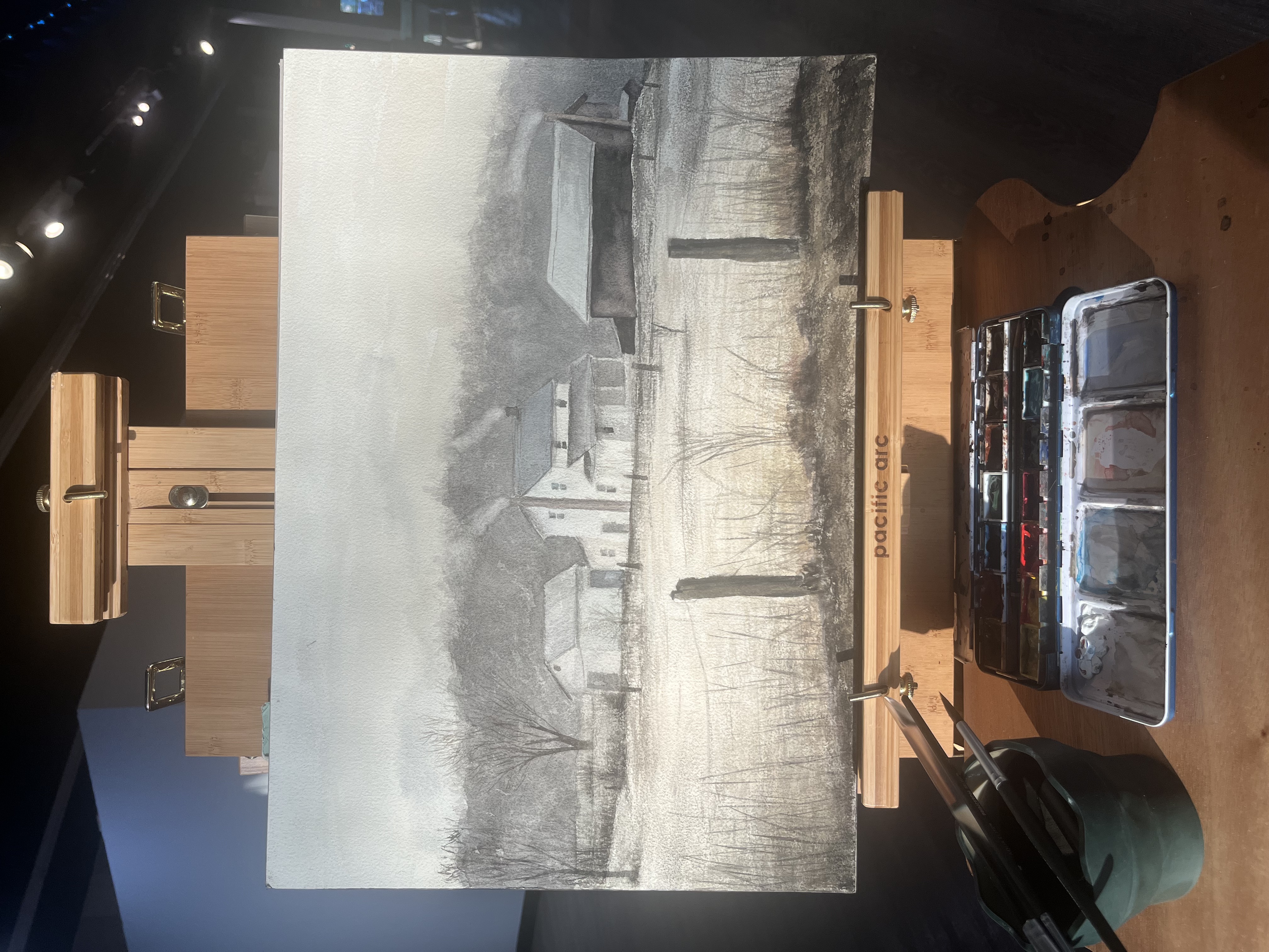 A watercolor painting in progress on the easel