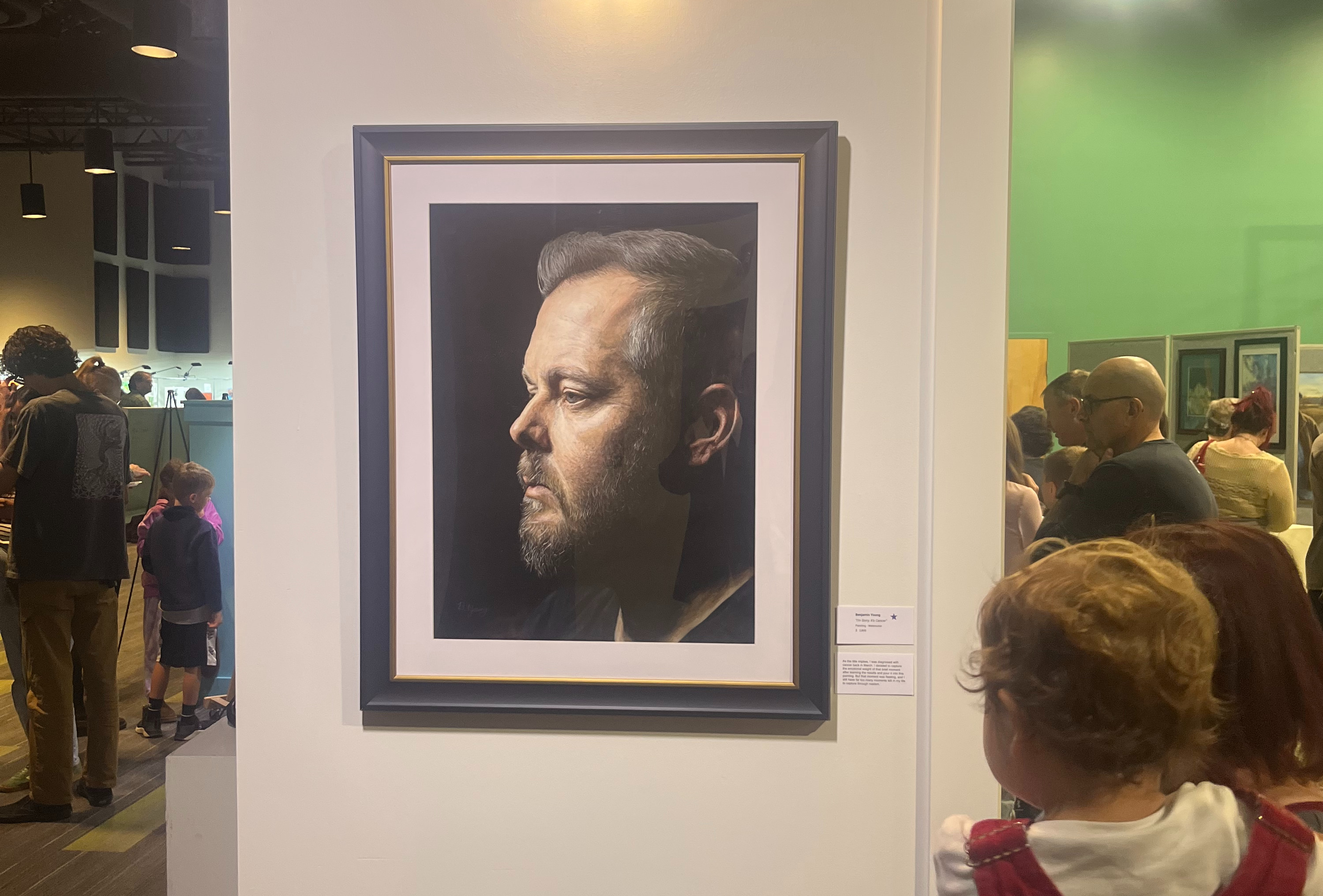 A crowd viewing artwork at Door 2 Art