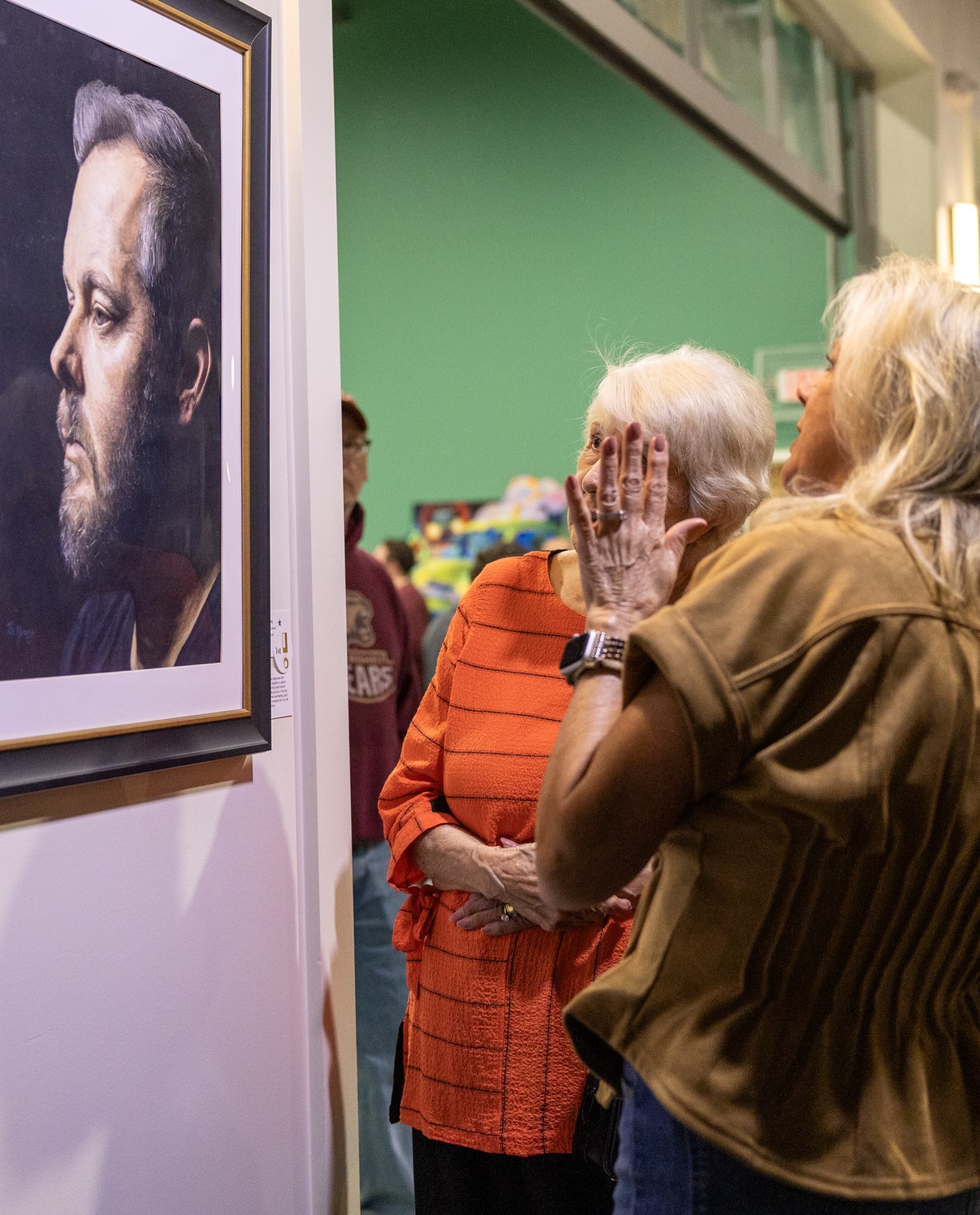Two members of an exhibit crowd inspecting I'm Sorry, It's Cancer